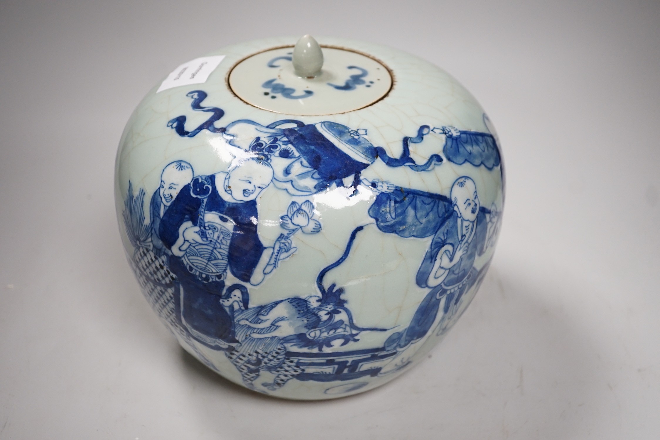 A Chinese underglaze blue and slip decorated celadon crackle glazed vase and associated cover, late Qing dynasty, 21cms high